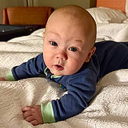 Markus joined the competition — help win amazing prizes! baby, bed, blue_clothing, child, cozy, curious, eyes, face, furniture, hand, head, indoor, infant, lying_down, pajamas, person, portrait, room, sleepwear, white_bedspread