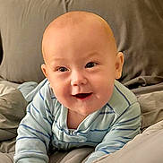 Markus joined the competition — help win amazing prizes! baby, infant, smiling, crawling, bed, blanket, clothing, onesie, happy, face, head, child, indoors, cozy, soft, comfort, person, cute, young, expression