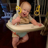 Markus is registered to the contest to win money with this photo: baby, baby_jumper, child, childcare, cute, face, furniture, happiness, happy, home, indoor, infant, joy, legs, people, play, room, smiling, swing, wooden_floor