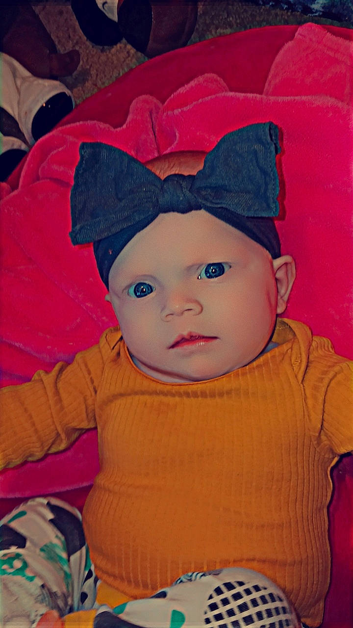 Isabella is registered to the contest to win money with this photo: baby, baby_toddler_clothing, cap, cheek, child, cool, costume_hat, electric_blue, eye, fashion_accessory, fun, happy, headgear, headwear, knit_cap, magenta, pattern, person, pink, skin