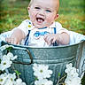 Weston joined the competition — help win amazing prizes! baby, child, smiling, outdoor, greenery, flowers, metal_bucket, happy, portrait, cute, nature, grass, person, infant, blue_eyes, summer, clothing, white_shirt, bowtie, garden