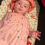Brianna a rejoint le concours — aidez-le/la à gagner de superbes lots ! baby, child, infant, hat, orange_hat, pink_dress, colorful_patterns, panda_blanket, lying_down, cute, puckered_lips, hand, playful, indoors, soft_lighting, portrait, smiling, young_child, clothing, face