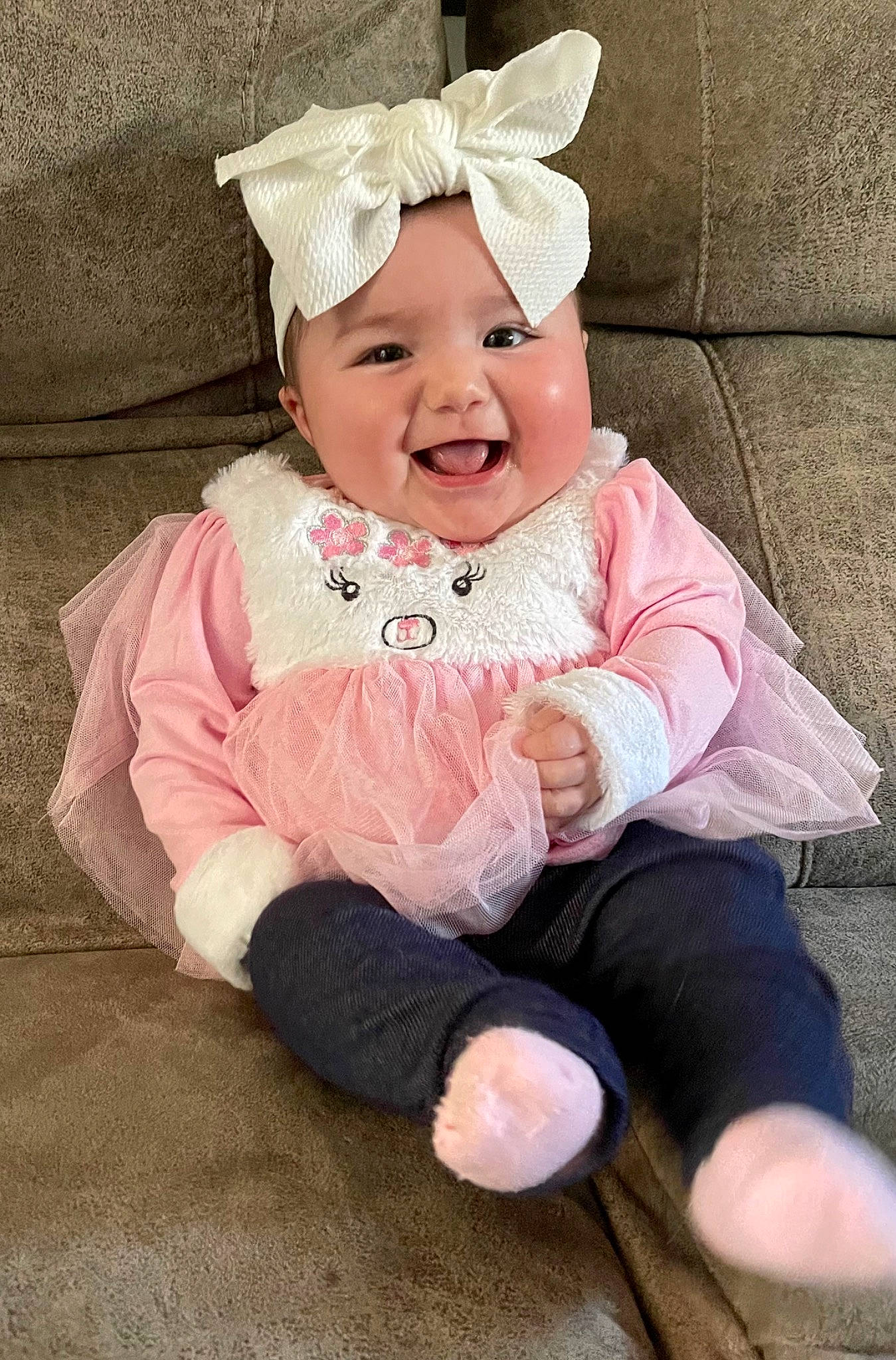 Sabrina is registered to the contest to win money with this photo: baby, baby_toddler_clothing, cheek, child, costume_hat, eye, fashion_accessory, grass, hair_accessory, happy, head, headband, headpiece, headwear, joy, laugh, magenta, person, pink, sitting