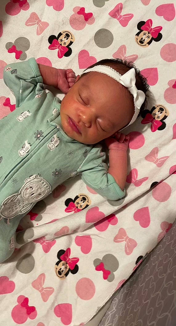 Sophia is registered to the contest to win money with this photo: baby, baby_products, baby_safety, baby_sleeping, baby_toddler_clothing, bedding, cheek, child, comfort, face, head, linens, pattern, person, pink, red, skin, sleeve, textile, toddler