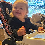 Tylee joined the competition — help win amazing prizes! child, clothing, curtains, cute, furniture, hair, happy, high_chair, home, indoor, light, living_room, person, seat, smiling, snack, table, toddler, toy, window