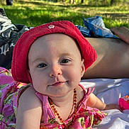 Harmony participe au concours pour gagner de l'argent avec cette photo : baby, blanket, child, cute, daylight, floral_dress, forest, grass, happy, infant, nature, necklace, outdoor, person, portrait, red_hat, relaxing, smiling, summer, sunlight
