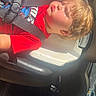 Logan is registered to the contest to win money with this photo: child, car_seat, seatbelt, sunlight, red_shirt, vehicle_interior, young_child, closed_eyes, daylight, car_window, road, seat, hair, relaxing, travel, safety, portrait, sunny, child_seat, casual_clothing