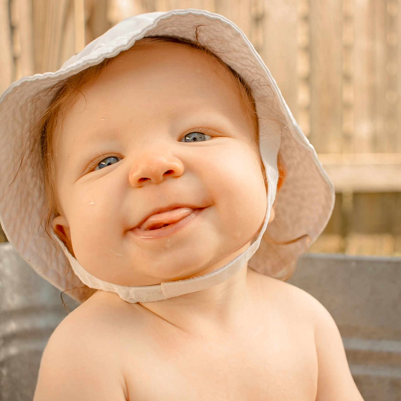 Logan joined the competition — help win amazing prizes! baby, babylaughing, bonnet, cap, clothing, face, happy, hat, head, person, photography, portrait, smile, sunhat