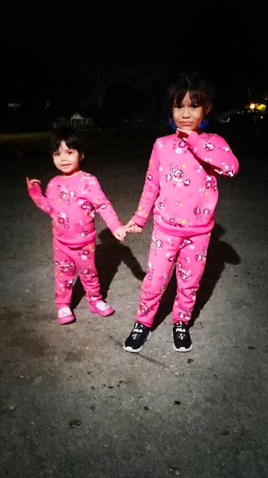 Sisters is registered to the contest to win money with this photo: arm, entertainment, event, face, flash_photography, fun, gesture, hand, happy, holding_hands, leisure, magenta, people_in_nature, person, pink, recreation, shoe, sleeve, standing, toddler