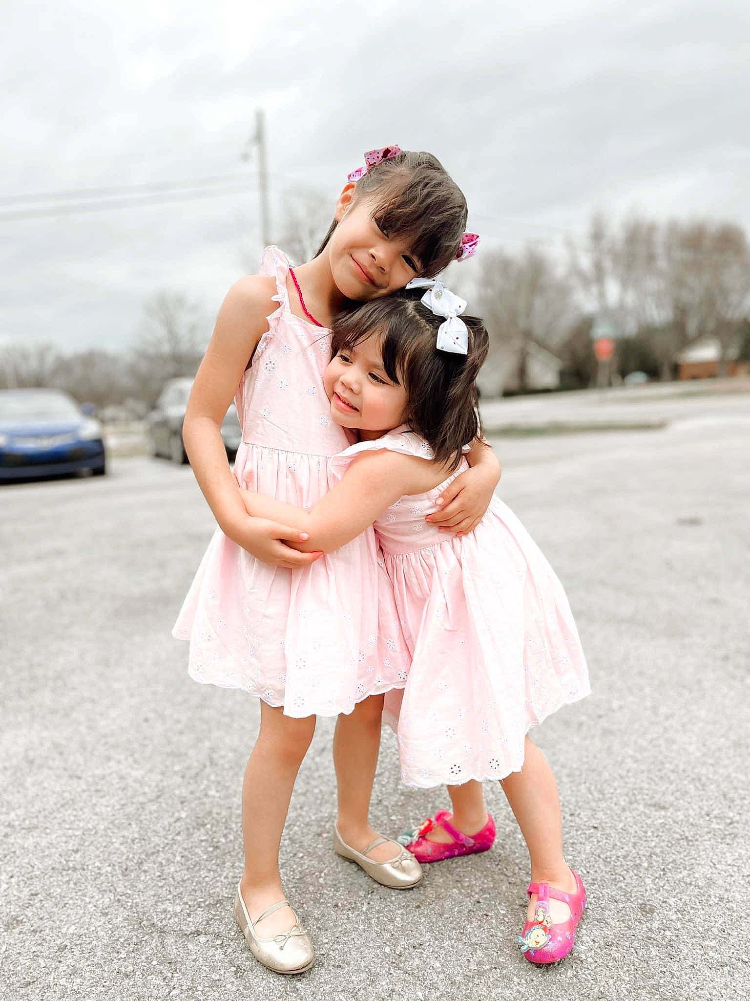 Sisters is registered to the contest to win money with this photo: bridal_clothing, bridal_party_dress, car, cloud, dress, event, flash_photography, footwear, formal_wear, fun, gesture, happy, joy, leisure, person, pink, sandal, shoe, shoulder, sky