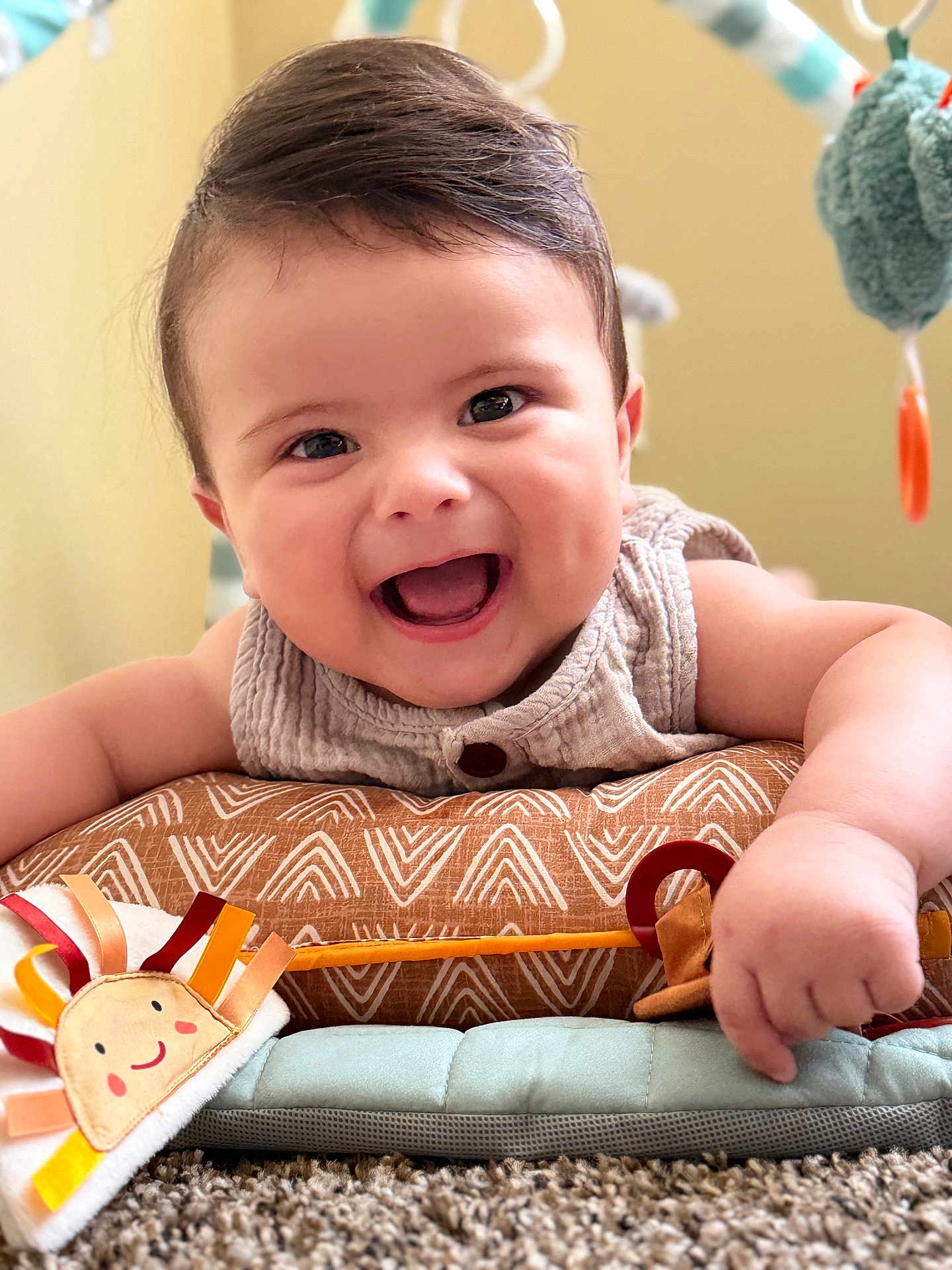 Isaac joined the competition — help win amazing prizes! baby, smiling, face, child, toy, play_mat, happy, infant, cute, indoors, soft_toy, carpet, chubby, toddler, clothing, closeup, expression, human, warm_colors, baby_girl