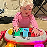 Clair-Ann is registered to the contest to win money with this photo: baby, child, toy, keyboard, headwrap, pink_clothing, carpet, indoor, hands, playing, colorful, light, infant, floor, piano, bright, cute, young, person, music