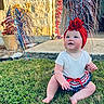 american_flag, baby, blue_eyes, celebration, child, cute, decorations, festive, grass, happy, holiday, outdoor, patriotic, porch, red_headband, sitting, skirt, summer, sunlight, white_shirt