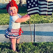 Clair-Ann joined the competition — help win amazing prizes! baby, blue, caucasian, child, flag, grass, happy, headband, holding, home, outdoor, patriotic, person, red, sidewalk, skirt, summer, sunlight, toddler, white