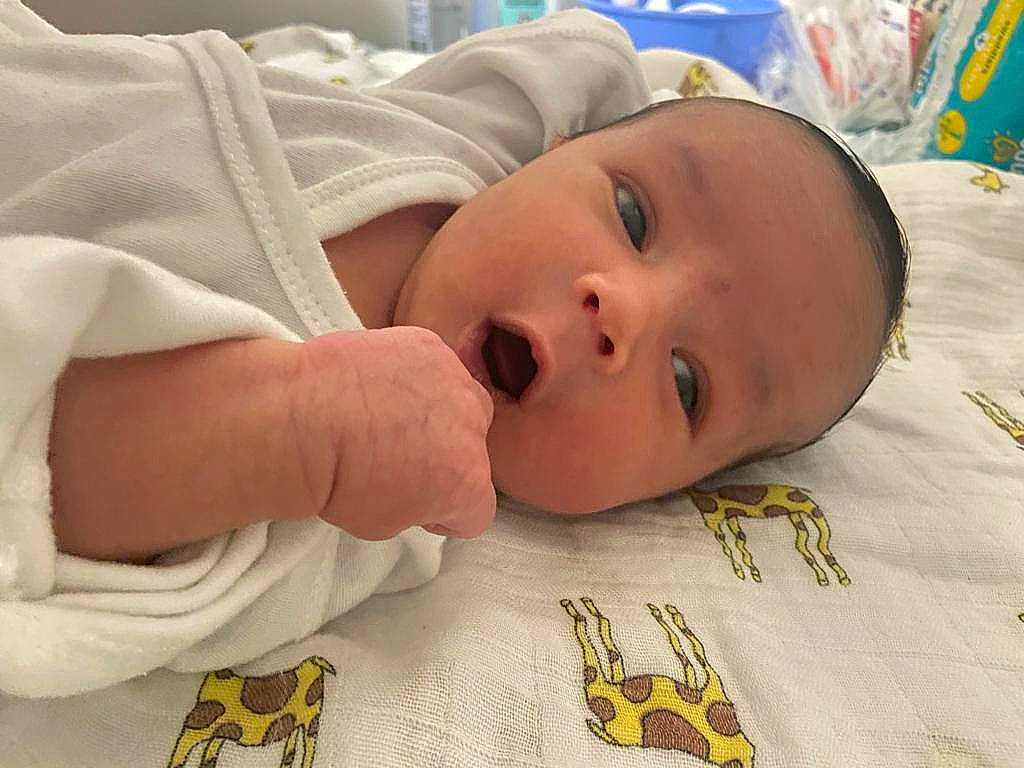 Darren is registered to the contest to win money with this photo: baby, baby_products, baby_safety, baby_sleeping, baby_toddler_clothing, bedding, bedtime, cheek, child, comfort, flooring, happy, linens, nail, person, room, skin, textile, thumb, toddler