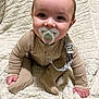 Walker is registered to the contest to win money with this photo: baby, pacifier, blanket, cozy, cute, infant, child, pajamas, sitting, soft, comfortable, indoors, young, face, hands, footed_pajamas, clothing, smiling, warm, texture