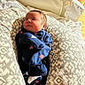 Isaiah joined the competition — help win amazing prizes! newborn, baby, infant, sleeping, blue_onesie, mittens, patterned_pillows, hospital_bed, blanket, face, head, person, indoor, soft_light, resting, cute, small, peaceful, child, cozy