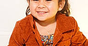 Amelia joined the competition — help win amazing prizes! child, girl, portrait, smiling, happy, sitting, indoor, fashion, jacket, corduroy, dress, floral_pattern, hair_bows, pigtails, earrings, necklace, brown_hair, studio_lighting, close_up, photography