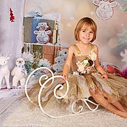 Erin a rejoint le concours — aidez-le/la à gagner de superbes lots ! child, dress, smile, sled, holiday, christmas_tree, ornaments, gift_box, plush_toy, reindeer, polar_bear, floor, carpet, decorations, winter, festive, indoor, portrait, happy, cute