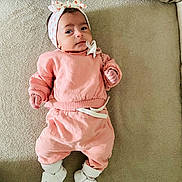 Ayla participe au concours pour gagner de l'argent avec cette photo : baby, infant, headband, bow, pink_outfit, socks, slippers, couch, blanket, pacifier_clip, hands, face, portrait, lying_down, cozy, soft_texture, expression, cute, home_interior, apparel