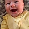 Stella joined the competition — help win amazing prizes! baby, smiling, yellow_outfit, bee_prints, happy, infant, cute, portrait, closeup, face, child, lying_down, blanket, patterned_blanket, indoors, soft_lighting, adorable, young_child, clothing, person