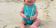 Heston joined the competition — help win amazing prizes! baby, child, beach, sand, hat, romper, smiling, sitting, outdoor, sunhat, happy, infant, footwear_none, nature, portrait, summer, vacation, cloudy_sky, playful, skin