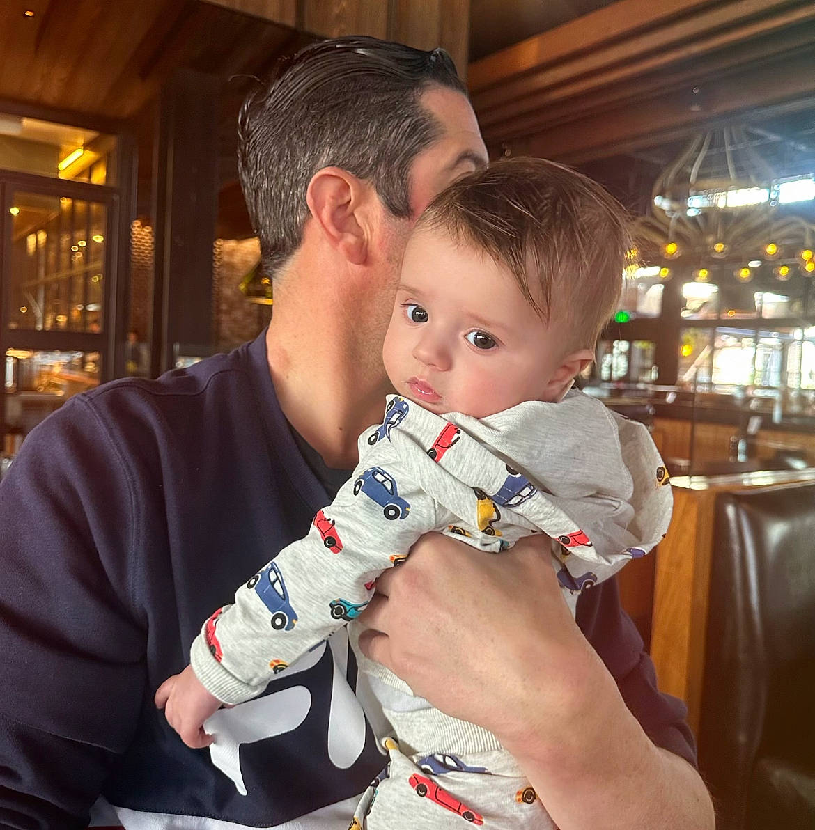 Liam is registered to the contest to win money with this photo: baby, carmine, child, ear, elbow, event, fun, hairstyle, happy, human_leg, lap, leisure, love, person, selfie, sitting, sleeve, sportswear, t_shirt, toddler