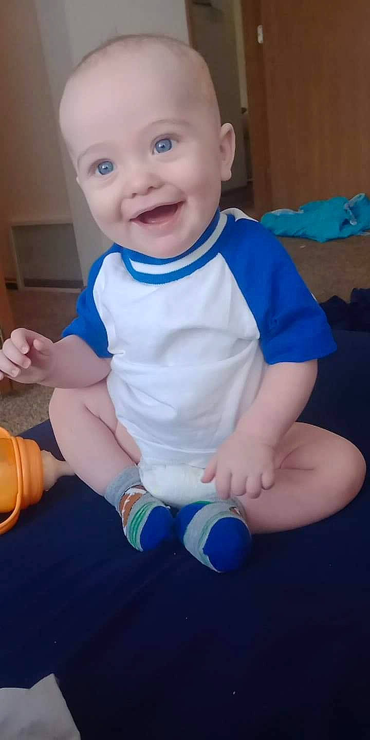 Tommy joined the competition — help win amazing prizes! baby, baby_toddler_clothing, blue, cheek, child, eye, facial_expression, finger, hand, happy, head, human_body, joy, knee, person, skin, sleeve, smile, standing, thumb