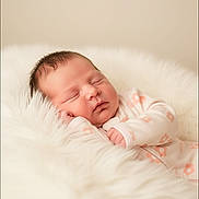 Haisley is registered to the contest to win money with this photo: baby, newborn, sleeping, infant, blanket, soft, floral_pattern, white, cute, peaceful, resting, face, head, clothing, portrait, cozy, child, closeup, indoors, warm
