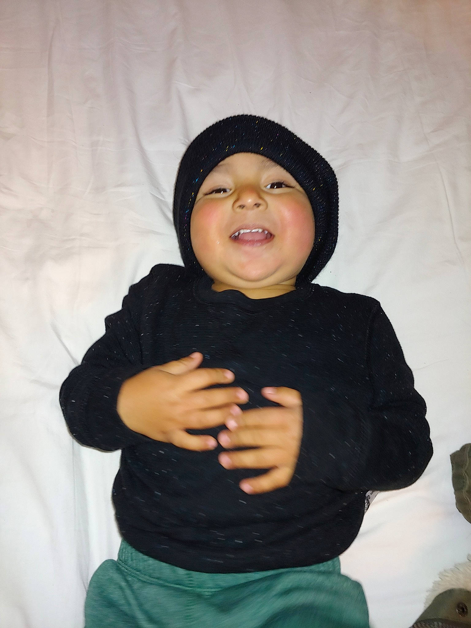 Domenic is registered to the contest to win money with this photo: beanie, black_hair, child, cool, finger, gesture, head, headgear, hoodie, knit_cap, outerwear, person, smile