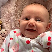 Tessamae joined the competition — help win amazing prizes! baby, smiling, infant, onesie, cherries, strawberries, blanket, plush_toy, soft_texture, cute, happy, lying_down, child, portrait, cozy, indoors, closeup, pink, warm, comfort