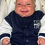baby, buttoned_jacket, casual_wear, cheeks, child, clothing, cushion, cute, face, happy, indoor, infant, infant_clothing, jacket, person, portrait, red_pants, seat, smiling, young_child