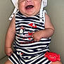 baby, beach_theme, cheerful, child, couch, crab_toy, cute, happy, hat, indoor, infant, person, playful, red_toy, sitting, smiling, striped_clothing, striped_outfit, toy, white_hat