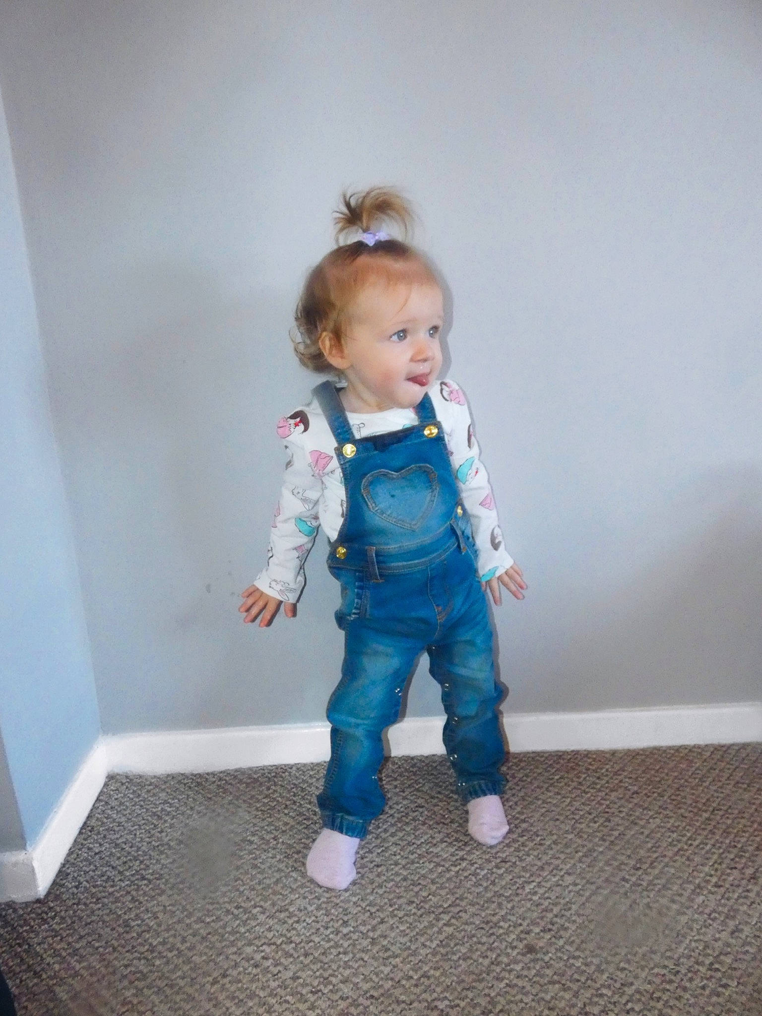 Elsie-mae is registered to the contest to win money with this photo: baby, blue, child, jeans, outerwear, overall, person, play, skin, sleeve, smile, standing, toddler
