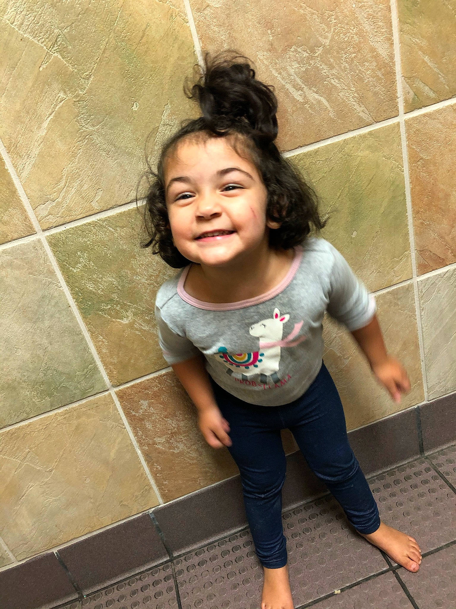 Evanna is registered to the contest to win money with this photo: child, floor, flooring, fun, happy, joy, leg, leisure, person, photography, smile, snapshot, standing, t_shirt, tile, toddler