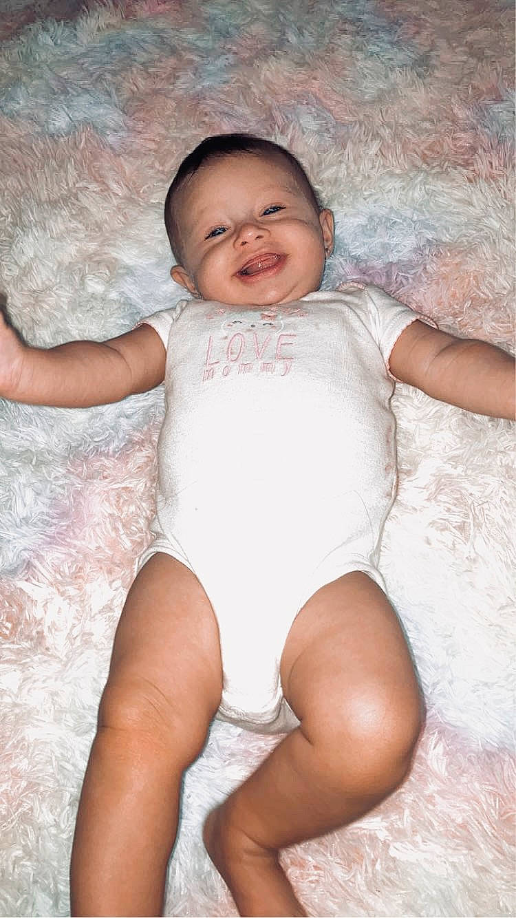 Rosalind joined the competition — help win amazing prizes! arm, baby, cheek, eye, finger, flash_photography, hand, happy, human_body, iris, leg, mammal, muscle, person, pink, skin, smile, standing, stomach, textile