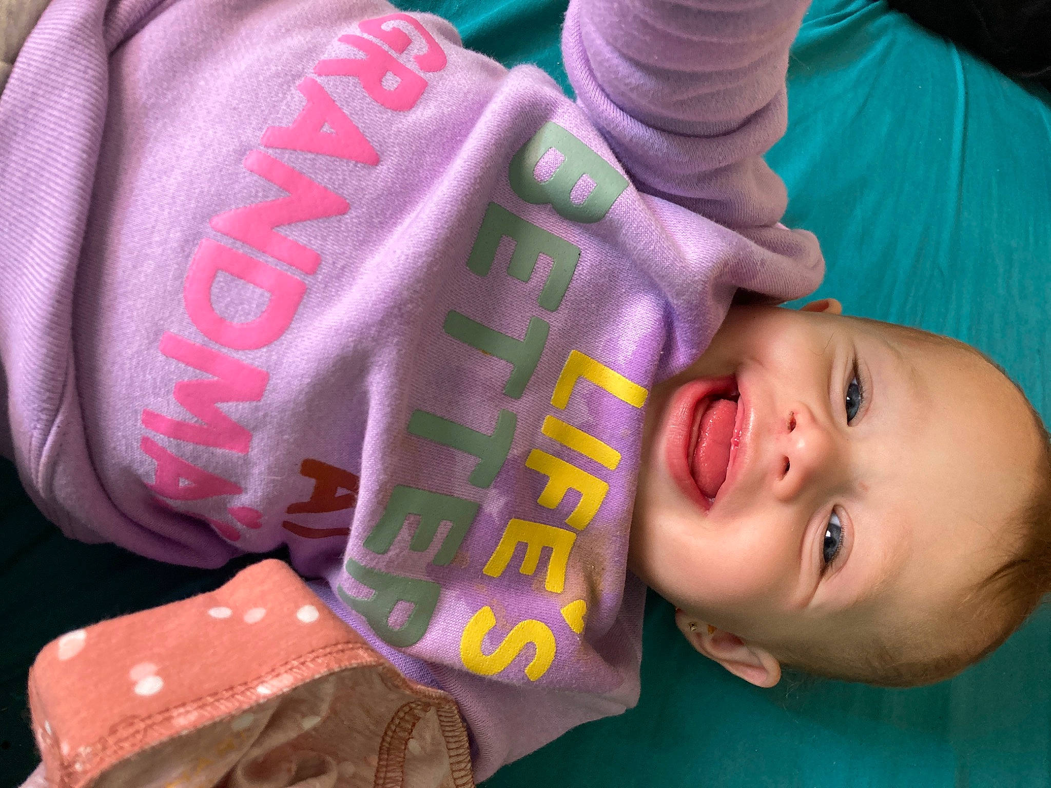 Rosalind is registered to the contest to win money with this photo: baby, baby_toddler_clothing, cheek, child, comfort, cool, eyelash, facial_expression, finger, green, hand, happy, mouth, nail, nose, person, personal_protective_equipment, pink, product, skin