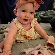 Anastasia is registered to the contest to win money with this photo: baby, child, smiling, headband, bow, dress, crawling, blanket, clothing, soft, indoors, cute, portrait, infant, pink, yellow, pastel, happy, person, cozy
