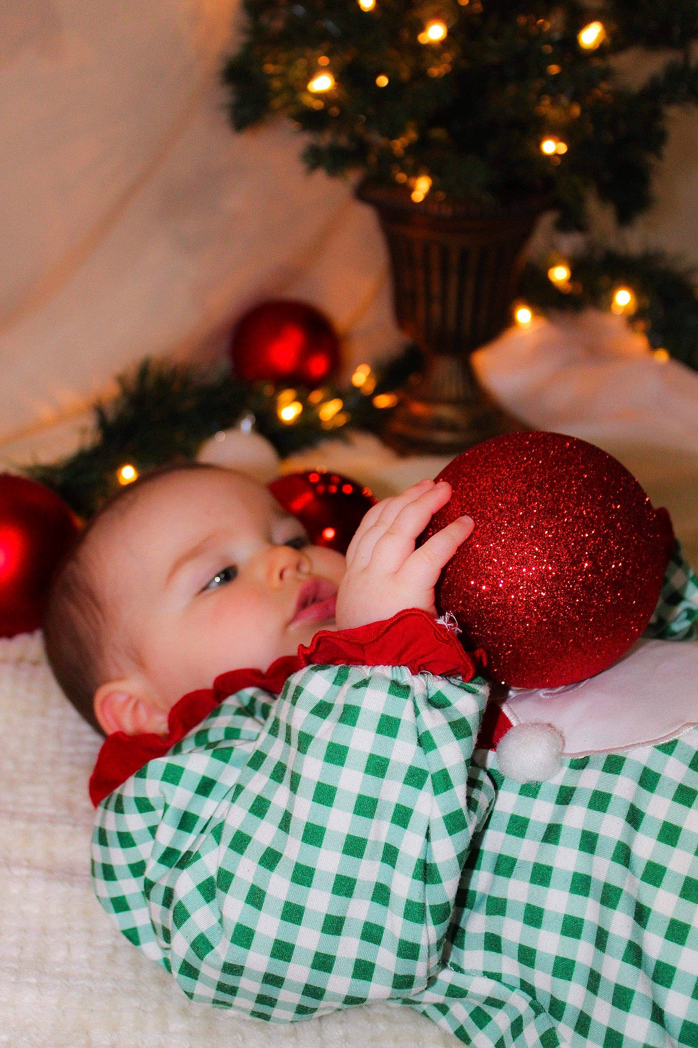 Alora is registered to the contest to win money with this photo: baby, baby_toddler_clothing, beauty, cheek, christmas, christmas_decoration, christmas_ornament, christmas_tree, event, facial_expression, happy, head, holiday, holiday_ornament, human_body, mammal, ornament, person, toddler, toy