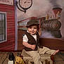 toddler, child, vintage_clothing, vest, flat_cap, barefoot, suitcase, teddy_bear, lantern, train_station, painted_backdrop, steam_locomotive, clock, indoor, portrait, smiling, floor, toy, cute, nostalgic