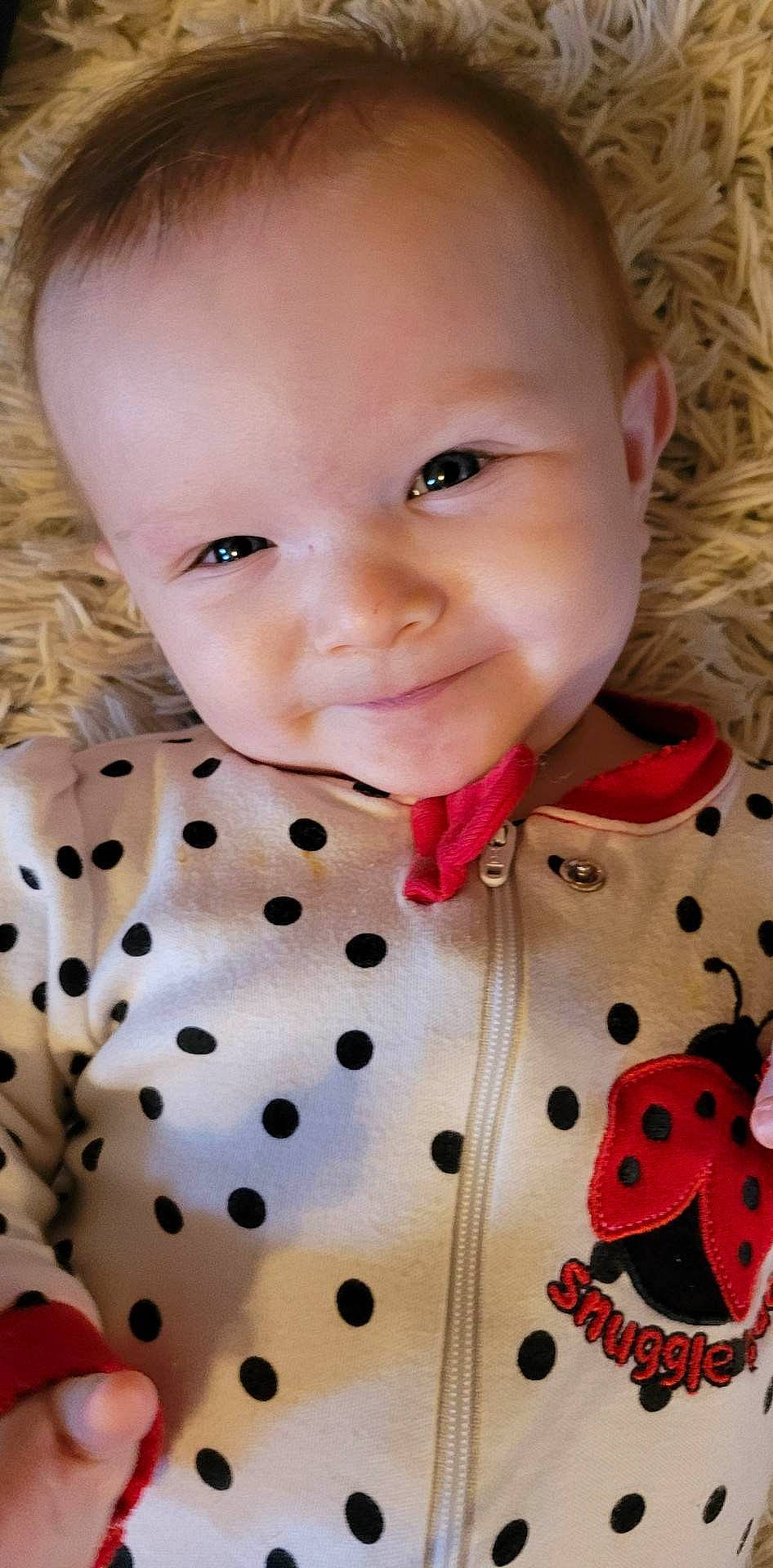 Carmen is registered to the contest to win money with this photo: baby_toddler_clothing, cheek, clothing, collar, face, facial_expression, happy, iris, lip, mouth, neck, nose, outerwear, person, pink, product, skin, sleeve, smile, textile