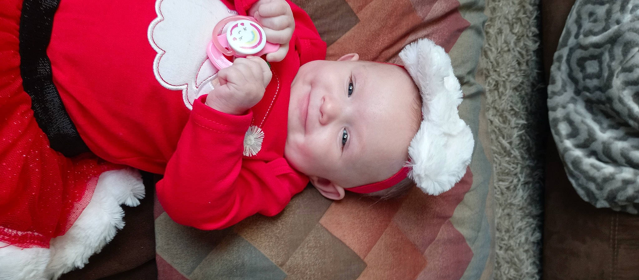 Carmen is registered to the contest to win money with this photo: baby, baby_products, baby_toddler_clothing, carmine, cheek, child, flower, grass, happy, hat, lip, magenta, person, petal, pink, plant, rose, sitting, sleeve, smile