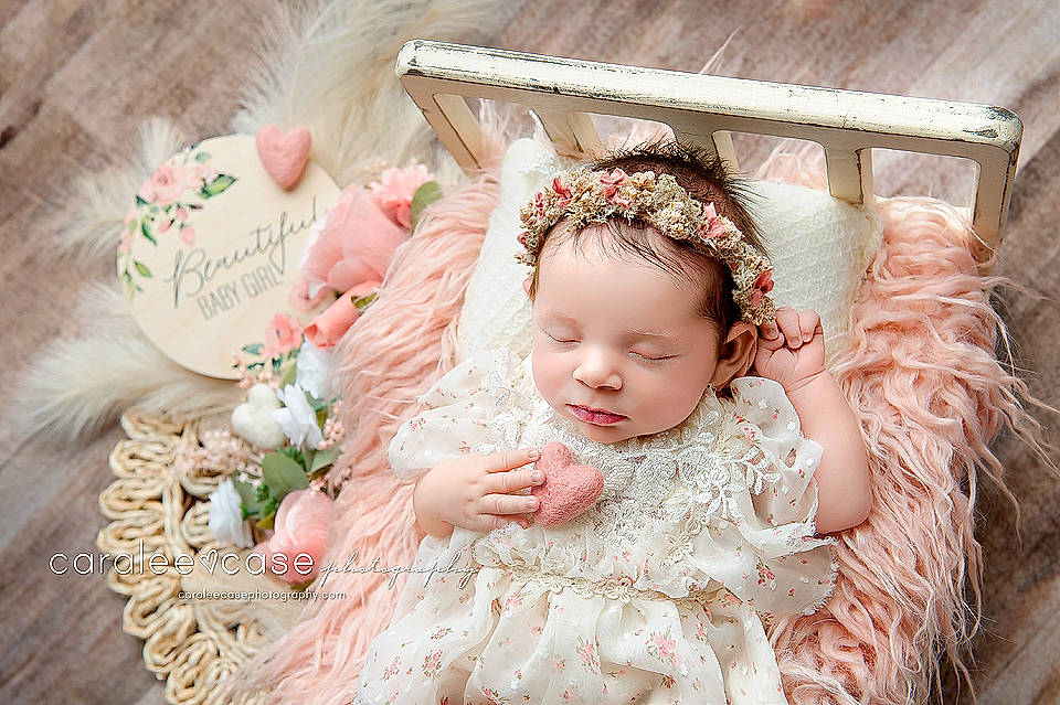 Annie joined the competition — help win amazing prizes! baby, baby_toddler_clothing, bridal_accessory, dress, embellishment, event, eye, eyelash, hair_accessory, happy, headband, headgear, headpiece, jewellery, peach, person, petal, pink, ruffle, sitting