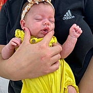 Harliegh joined the competition — help win amazing prizes! adidas_logo, adult_hand, baby, black_shirt, close_up, cute, face, fingers, floral_pattern, headband, holding, human, infant, outdoor, peaceful, person, portrait, skin, sleeping, yellow_outfit