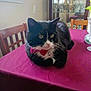 Pickles is registered to the contest to win money with this photo: cat, tuxedo_cat, bow_tie, collar, bell, table, tablecloth, maroon_tablecloth, chair, dining_room, china_cabinet, vase, glassware, indoor, pet, whiskers, closeup, portrait, curious, furniture
