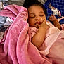 Alani joined the competition — help win amazing prizes! baby, bed, blanket, child, comfort, cozy, cute, face, hand, indoors, infant, peaceful, pink, portrait, resting, sleeping, soft, toddler, toys, young