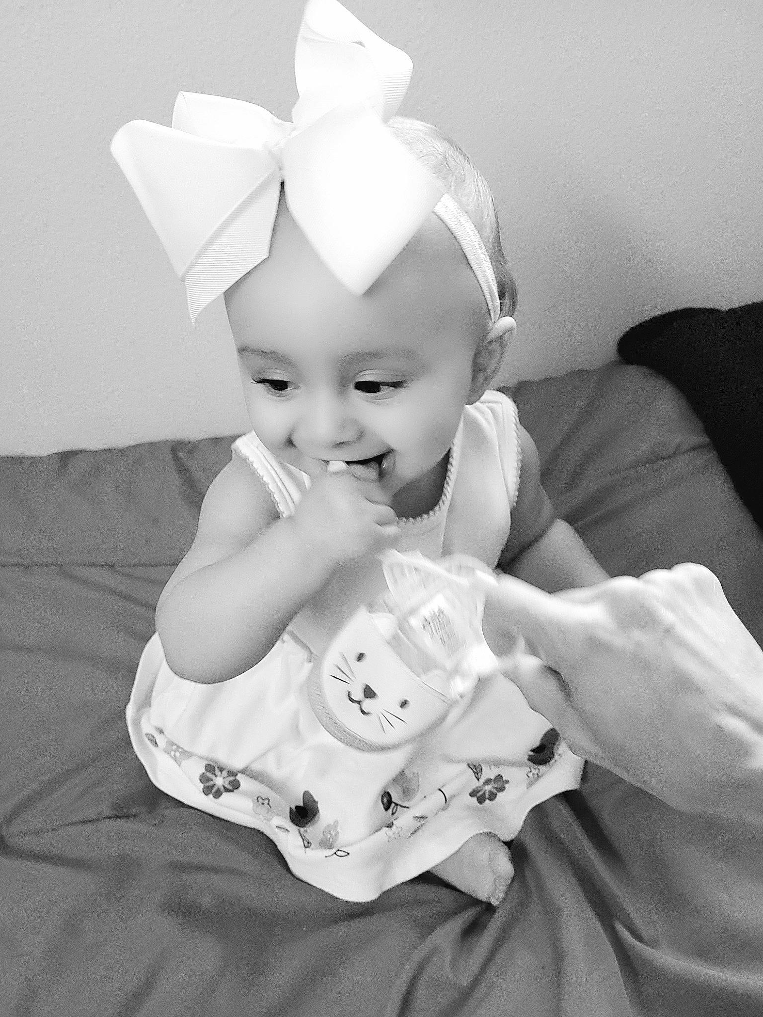 Chanel is registered to the contest to win money with this photo: art, baby, baby_toddler_clothing, child, comfort, costume_hat, drinkware, eye, fashion_accessory, head, headband, headpiece, iris, joy, monochrome, monochrome_photography, person, room, sleeve, style