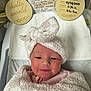Octavia joined the competition — help win amazing prizes! baby, birth_details, blanket, celebration, cute, face, head_wrap, hospital, hospital_bassinet, infant, lying_down, newborn, person, pink, portrait, smiling, soft_texture, white, wooden_plaques, wrapped