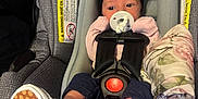 Octavia is registered to the contest to win money with this photo: baby, black, blanket, bow, car_seat, checkered, child, clothing, cute, footwear, gray, headband, indoors, infant, newborn, pacifier, person, pink, safety_harness, shoe