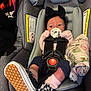 baby, black, blanket, bow, car_seat, checkered, child, clothing, cute, footwear, gray, headband, indoors, infant, newborn, pacifier, person, pink, safety_harness, shoe